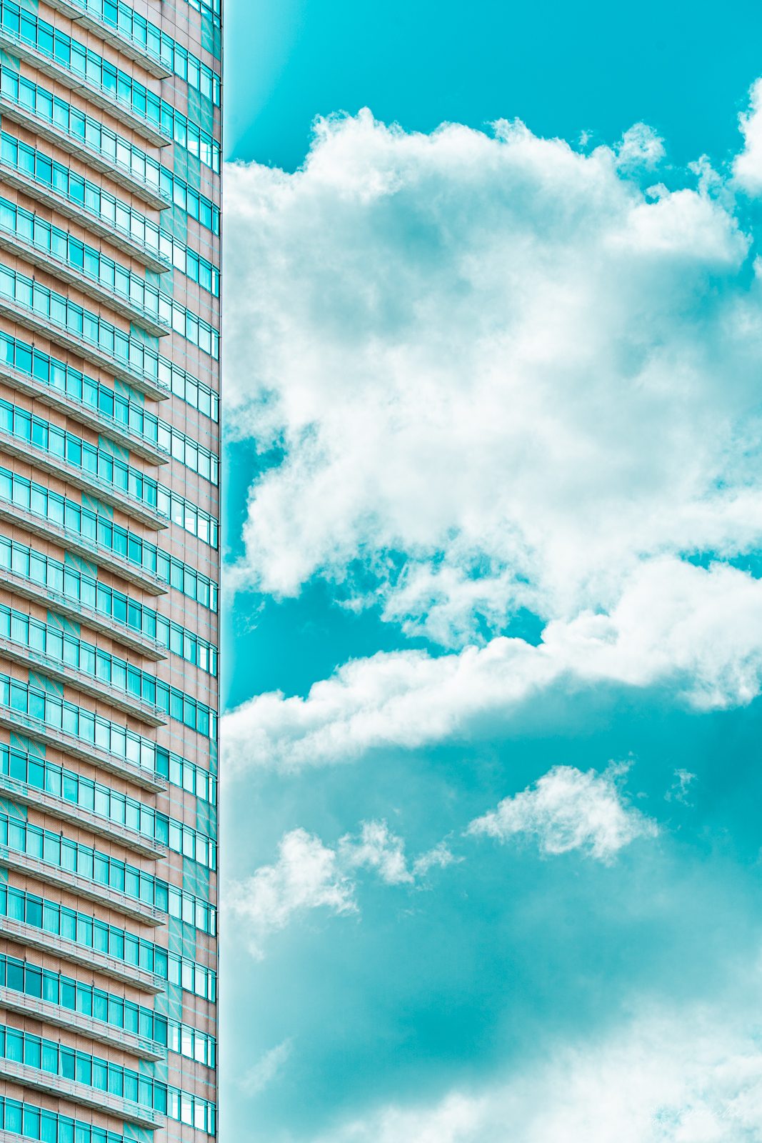 A high-rise facade against vivid blue sky