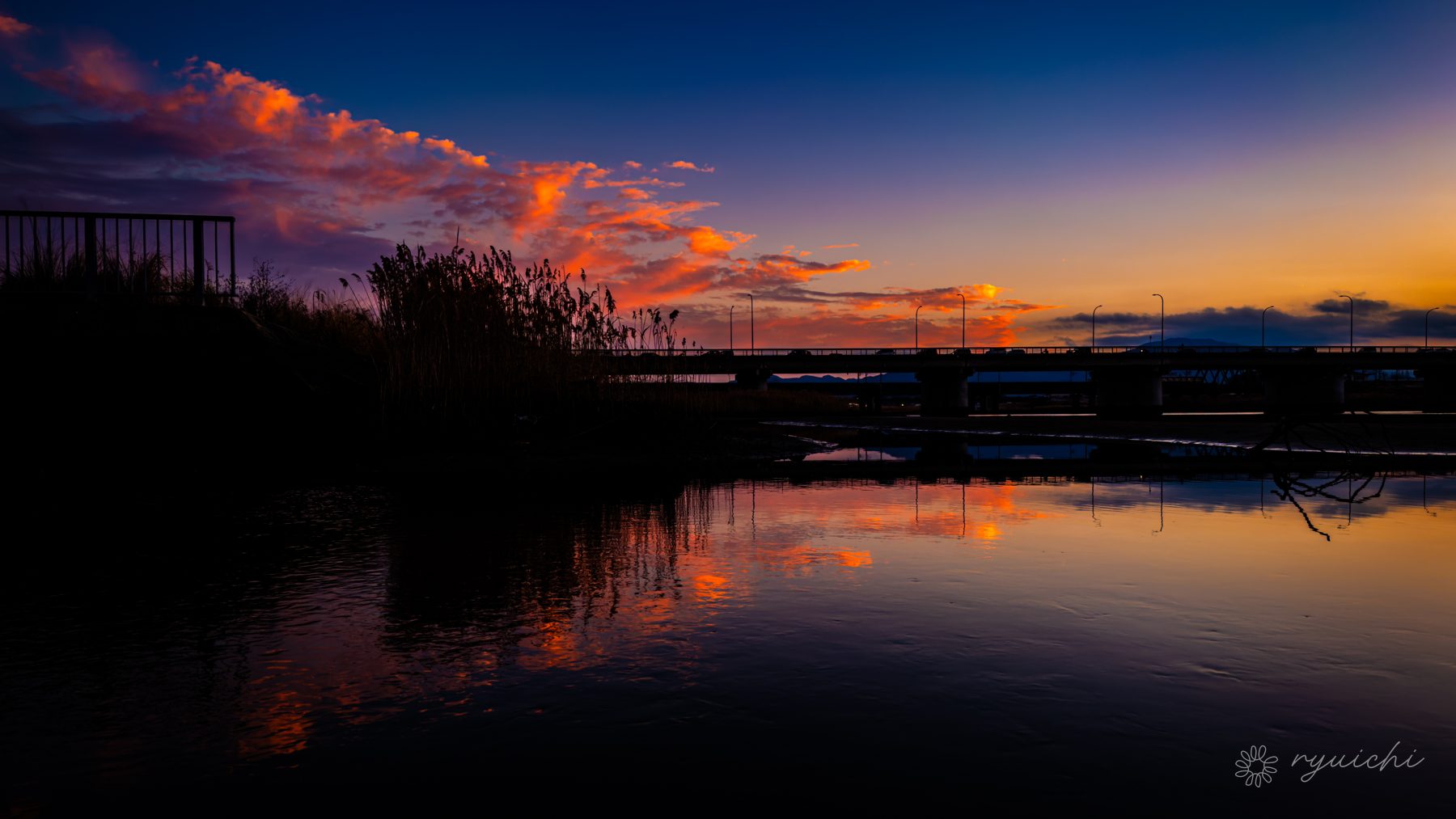 Afterglow reflected on a still waterside